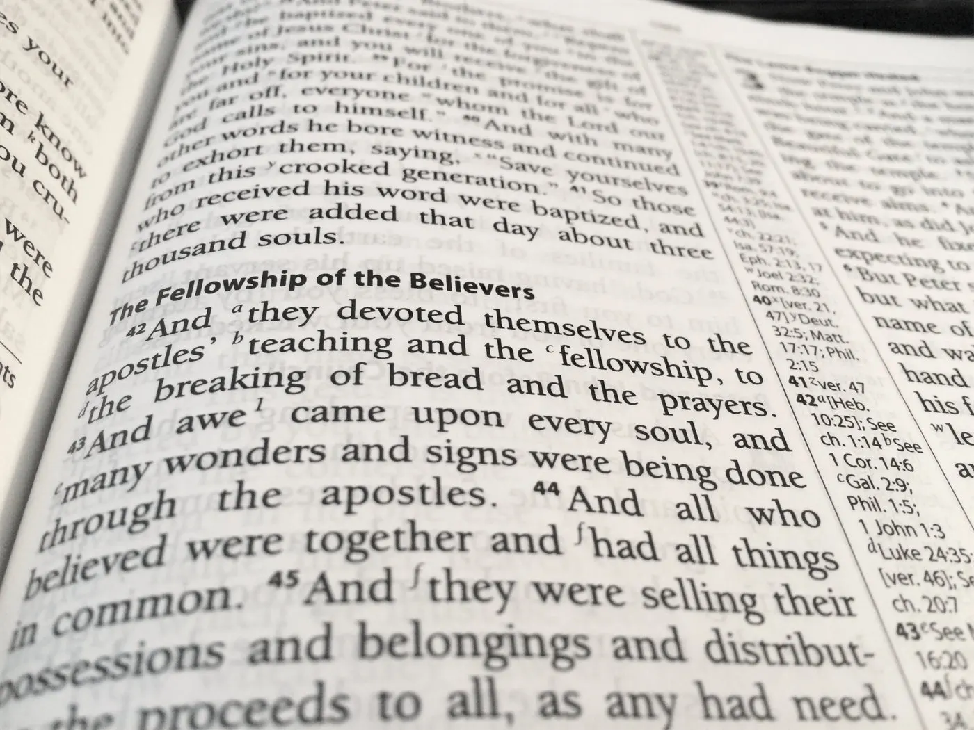 An open Bible at Acts 2, “The Fellowship of the Believers”