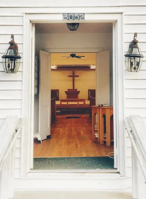 The open front door of the church looking toward the cross